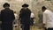 A number of jewish men pray in a room at the wailing wall in Jerusalem