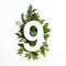 Number nine shape with green leaves. Nature concept. Flat lay. Top view