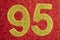 Number ninety-five golden color over a red background. Anniversary