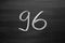 Number ninety six enumeration written with a chalk on the blackboard