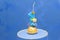 Number one candle on a blue background. Little prince theme. Fake birthday cake with personalized candle for first birthday for