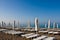 A number of plank beds and umbrellas on a beach