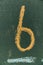 Number six written hand chalk on board. Text number six on chalkboard