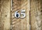 Number sixty five on wooden gate