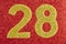 Number twenty-eight golden color over a red background. Anniversary