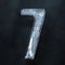 Numeric value, numbers made out of ice isolated on dark studio background