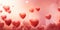 Numerous red hearts on a pink gradient background