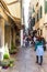 Numerous tourists and residents walk around Calle de la Mandola in Venice, Italy