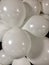 Numerous white balloons