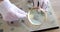 Numismatist examining old coin with magnifying glass closeup 4k movie slow motion