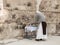 A nun is preparing a table with religious supplies for prayer on the ruins of a Byzantine church complex on the territory of