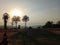 The nun wearin white dress watching the sunrise. Dharma practice with nature concept. Backlight image of the sky and sunrise with