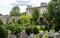 Nunney Castle with church grave yard in the foreground in Nunney, Somerset, UK