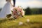 Nuptial scene Wedding bouquet rests on grass with married couple