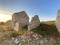 Nuraghe Serbissi view at sunset with grass around, golden sky background