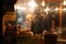 NUREMBERG, GERMANY - DECEMBER 22, 2013: Stylish salesman sells sausages at night at the Christmas fair, Nuremberg, Germany