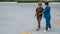 A nurse accompanies an elderly blind woman on a walk.