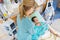 Nurse Adjusting Young Patient\'s Pillow In Hospital