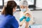 nurse applying medical patch to vaccinated woman