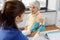 nurse applying medical patch to vaccinated woman