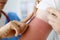 Nurse applying protective cream to skin of hand with burn closeup