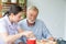 Nurse assist senior man having breakfast together