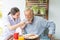 Nurse assist senior man having breakfast together