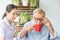 Nurse assist senior man having breakfast together