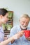 Nurse assist senior man having breakfast together