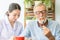 Nurse assist senior man having breakfast together