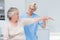 Nurse assisting senior patient in exercising at clinic