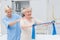 Nurse assisting senior patient in exercising with resistance band