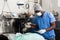 Nurse assisting surgeon in an operating room of veterinary clinic