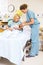 Nurse Assisting Woman In Holding Newborn Baby At