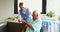 Nurse bringing cake for senior man birthday