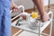 Nurse bringing patient`s food and medicine on serving trolley, closeup. Doctor`s prescription