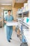 Nurse Carrying Container In Hospital Storage Room