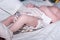 Nurse changing diaper of newborn baby in neonatal intensive care unit