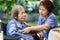 Nurse checking lung of elderly woman during homecare medical