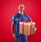 Nurse with clown nose and gift on red background