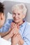 Nurse comforting elderly woman