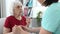 Nurse Comforts Elderly Woman In Conversation