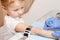 Nurse disinfects arm of little girl before performing a venipuncture