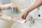 Nurse disinfects a patients hand at a sink