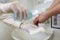 Nurse disinfects a patients hand at a sink