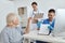 nurse and doctor examining an elderly woman hospital diagnosis