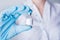 Nurse or doctor holding a vaccine, medicine. Hand in a blue glove