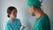 Nurse and a doctor in a hospital room discuss a patient`s treatment regimen. Clinic medical staff at work