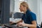 Nurse on Duty working on computer at the Reception Desk in modern clinic