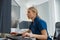 Nurse on Duty working on computer at the Reception Desk in modern clinic